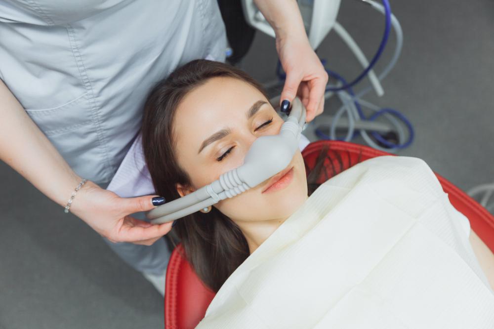 A woman receiving nitrous oxide sedation in Corona, CA