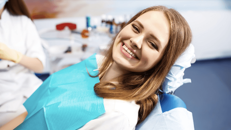 A smiling woman getting a dental cleaning
