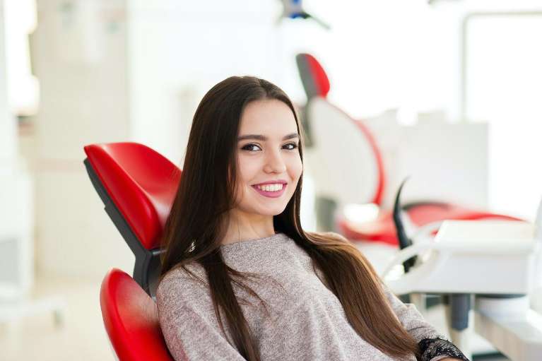 A smiling woman at the dentist