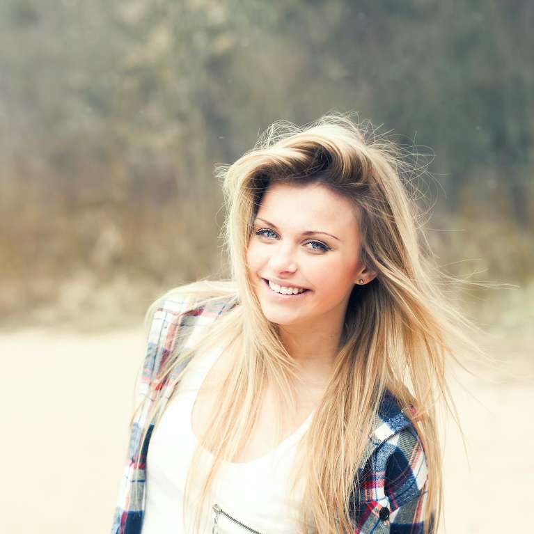 A girl smiling in the park