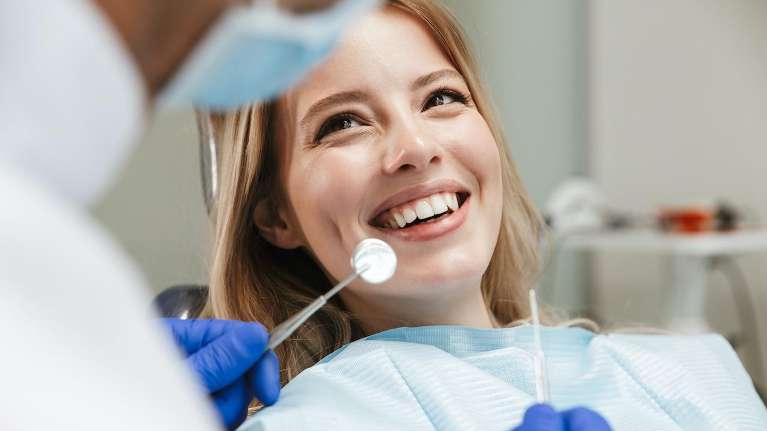woman smiling during dental exam