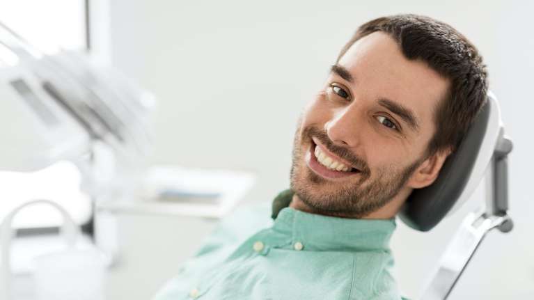 A smiling man at the dentist