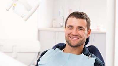 A smiling man in the dentist's chair