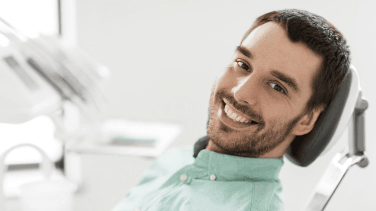 A smiling man at the dentist