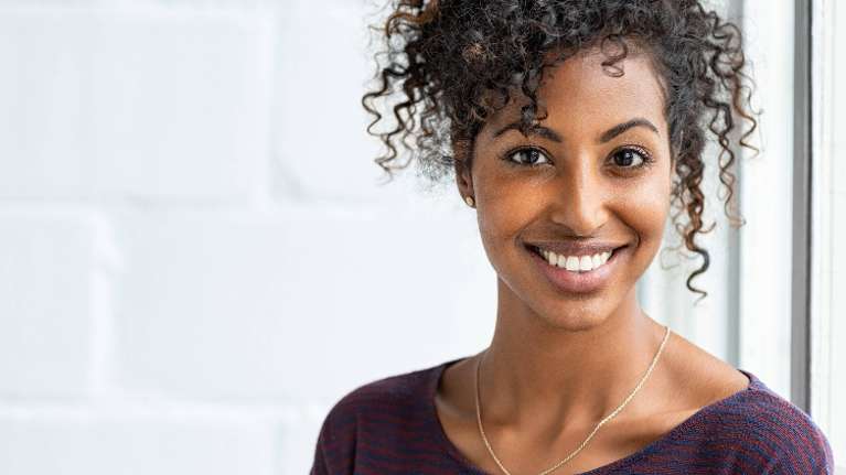 A smiling woman | dental hygiene Corona, CA