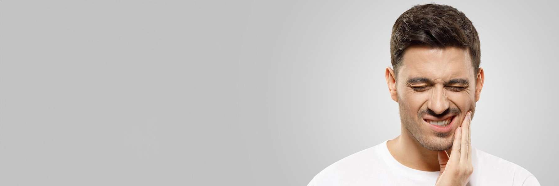 A man with tooth and jaw pain | emergency dentist Corona CA