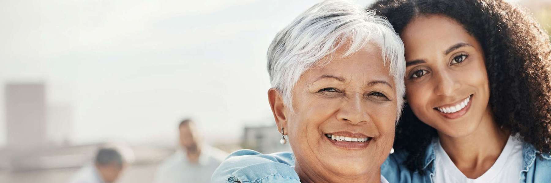 An older mother and her daughter smiling